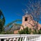 View of the bell tower, main entrance, and white cross of San Miguel Church in Santa Fe, New Mexico, USA
