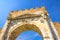 View from below of ancient brick wall and stone gate Arch of Augustus Arco di Augusto ruins in Rimini