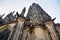 View from below on tall ancient the St. Vitus Cathedral with statues in Prague