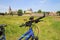 View beyond handlebar of bicycle over green rural landscape on church and castle of medieval village focus on handlebar