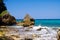 View beyond sharp rocks on turquoise rough sea with wave breakers and strong surf - Blue lagoon, Portland, Jamaica