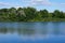 View of the Biesdorfer Baggersee lake with magnificent vegetation in August. Berlin, Germany