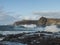 view of big breaking waves with foam splash and coastal cliffs at natural sea pool Las Salinas de Agaete in Puerto de