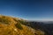 View from the big plateau full of grass and rock to Rax valley with dark blue sky