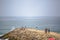 View of a big seawall on atlantic ocean and people enjoying the view and fishing