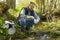 View of a Biologist take a sample in a river.