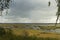 View from bird watching tower in Kanieris, Latvia. Sunset pink skies, river with deep blue reflection and trees.