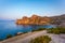 View of Black Sea bay with rocky shore, stony path with bushes a