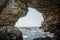 View of the Black Sea through a natural stone arcade in Tyulenovo, Bulgaria