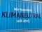 View on blue billboard at aldi discounter store facade with german text we are acting climate neutral since 2017