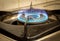 View of blue flames on gas stove burner