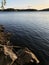 View of the blue lake from the rocky shore, vertical photo