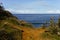 View on blue sea from grassy hill with path