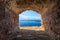 View of blue sea seascape from hole window frame in old stone wall