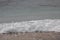 the view of the blue sea water with waves and foam that looks white