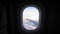 View of the blue sky and clouds through the window of the aircraft. Airplane window with airplane wing.