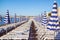 View of the blue striped umbrellas on the beach in Nice, Cote d`Azur, Southern France