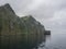 view from boat on steep green Hornbjarg cliffs biggest bird cliffs in Europe, west fjords, remote nature reserve Hornstrandir in