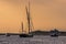 A view of boats moored at Blakeney Point, Norfolk looking towards the lifeboat station in the distance just before sunset