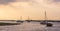 A view of boats moored at Blakeney Point, Norfolk at low tide just before sunset