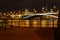 View of Bolshoy Kamenny Bridge and Moscow Kremlin with night illumination on a background of pleasure boats pier