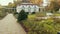 View in Botanical garden. Decorative tropical trees plants around it rest bench