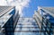 A view from the bottom up to a modern tall office building with countless rows of identical windows