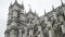 View from the bottom on the Westminster Abbey exterior details against the grey cloudy sky. Action. It is a large