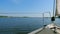 View from bow of sailing yacht ashore on a summer day.