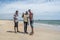 View of boys in posing for photography on the beach next to ships graveyard