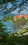 View through branches to tegernsee castle and harbour with boats, upper bavaria