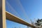 View of the bridge against the blue sky. The cables and high pylons of this long cable-stayed road bridge. Steel and