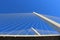 View of the bridge against the blue sky. The cables and high pylons of this long cable-stayed road bridge. Steel and