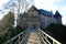 View on bridge over moat to entrance gate of medieval water castle  with bare trees in winter - Krefeld Linn, Germay