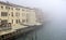 View from the bridge Ponte degli Scalzi in the Grand Canal in Venice on a cold and foggy winter day