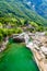 View from Bridge Ponte dei Salti to Verzasca River at Lavertezzo - clear and turquoise water stream and rocks in Ticino - Valle