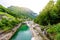 View from Bridge Ponte dei Salti to Verzasca River at Lavertezzo - clear and turquoise water stream and rocks in Ticino - Valle