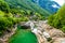 View from Bridge Ponte dei Salti to Verzasca River at Lavertezzo - clear and turquoise water stream and rocks in Ticino - Valle