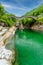 View of Bridge Ponte dei Salti to Verzasca River at Lavertezzo - clear and turquoise water stream and rocks in Ticino - Valle