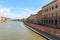 View from the bridge Ponte di Mezzo to the Lungarnos the streets along the bank of the Arno river through Pisa, Tuscany, Italy