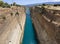 View from the bridge to the boats and yachts passing through the Corinth Canal from a sunny day on Peloponnese in Greece