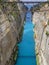 View from the bridge to the boats and yachts passing through the Corinth Canal from a sunny day on Peloponnese in Greece