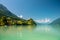 View of Brienz lake with clear turquoise water. Traditional wooden houses on the shore of Brienz lake in the village of