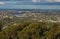 View of Brisbane Queensland Australia from lookout on top of Mt Coot-tha with trees in the foreground and a Kookaburra bird