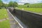 View of a British canal lock in rural setting