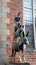 View of bronze statue of the Town Musicians of Bremen in old city centre, beautiful houses on the background, Bremen, Germany