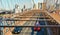 View on Brooklyn bridge and Hudson river with cars running and modern skyline in background in Manhattan, New York