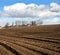 View at the brown arable fields when preparing land for sowing in early spring