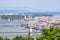 View on Budapest from Gellert Hill, Hungary. Ancient houses with tiled roofs, majestic palaces and basilicas against a cloudy