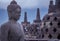 View of Buddha statue on a misty morning at Borobudur Temple